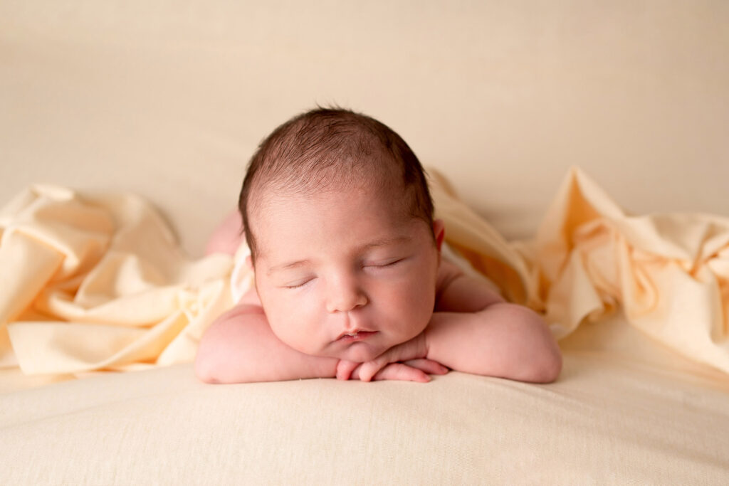 newborn head on hands